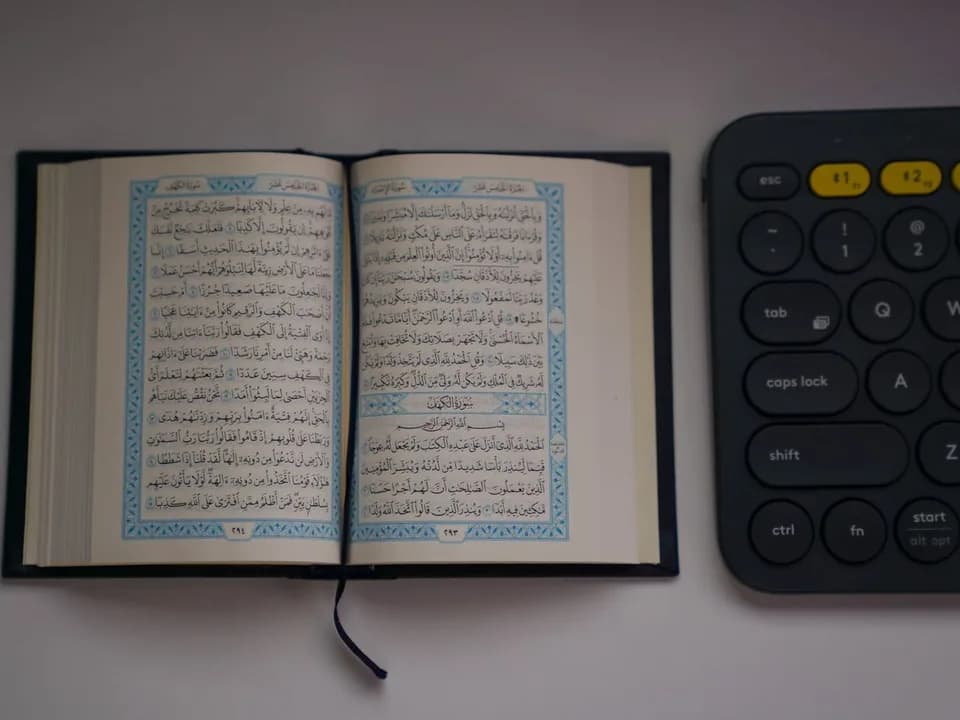 Open Quran beside a keyboard for online Quran learning