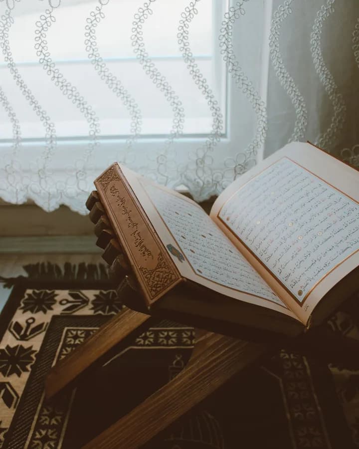 Open Quran on a wooden rehal in a peaceful home study setting
