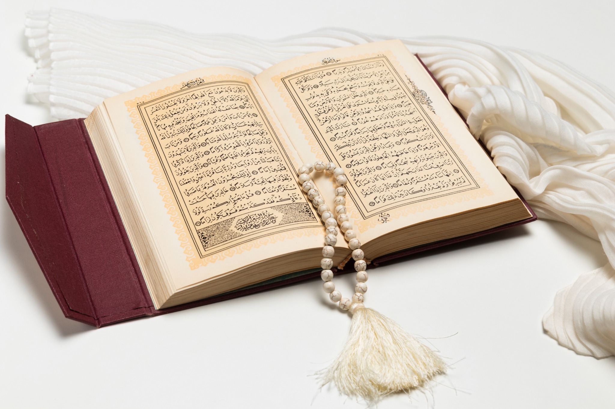 An open Quran with a prayer bead (Tasbih) resting on its pages, symbolizing Islamic faith and devotion, Online Quran, Online Quran learning Quran classes online Learn Quran online Quran tutoring services Online Quran teaching Best online Quran courses